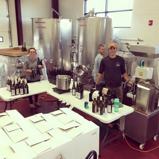 People bottling wine in Liquid Art Winery in Kansas, USA.