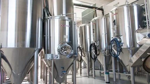 Assortment of conical fermenters in a craft brewery.